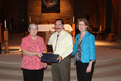 Orville's family accepting his award from St. Joseph's Indian School.