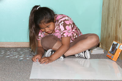 Lakota student playing with a puzzle.