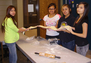 Lakota girls making pasta.