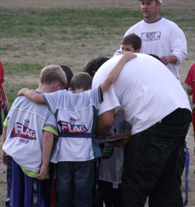 Cody in a huddle with his team.