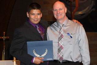 Caden poses with Mike Tyrell and his 8th grade certificate.
