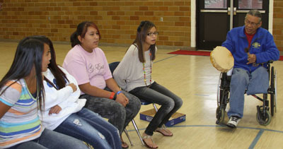 St. Joseph's students learning Lakota hand games.