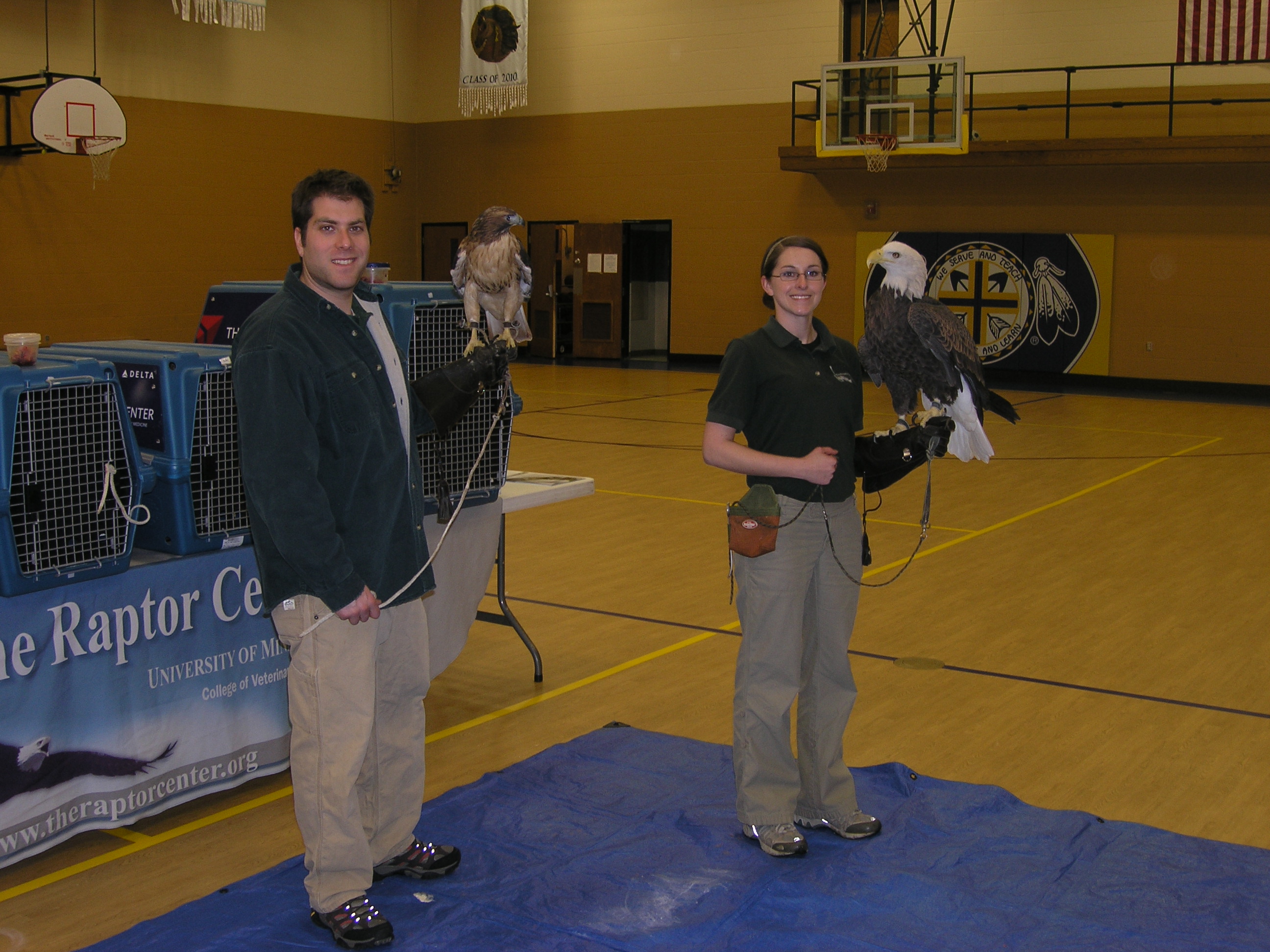 Adam and Katie with two of the Raptor Center's Birds.
