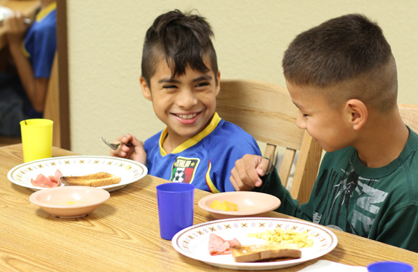 Lakota boys enjoying breakfast in their home at St. Joseph's