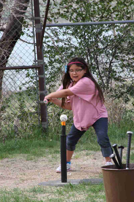 A Lakota child learning how to hit in T-ball